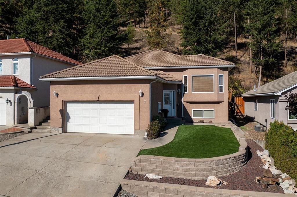 A house with a brown roof and a white garage door.